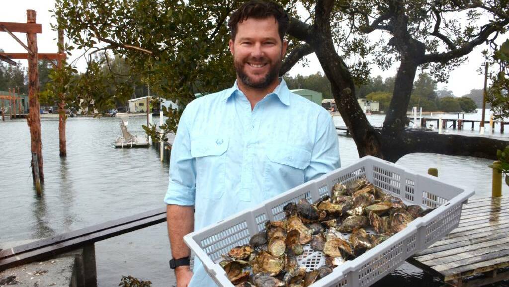 Oceanfarmr CEO Ewan McAsh holds a basket of Sydney rock oysters at his family farm on the Clyde River, Batemans Bay. Picture by Claudia Ferguson.