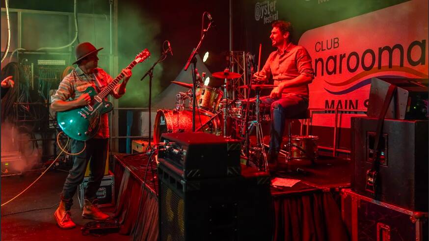 Narooma Oyster Festival attracts celebrity chefs like Colin Fassnidge, pictured here doing an impromptu drumming jam with Benji & the Saltwater Sound System on Friday, May 5, before the fireworks countdown. Picture supplied.
