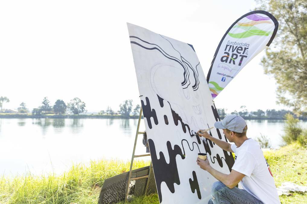 Street artist Happy Decay paints beside the Moruya River during the 2019 River of Art festival. Picture supplied 