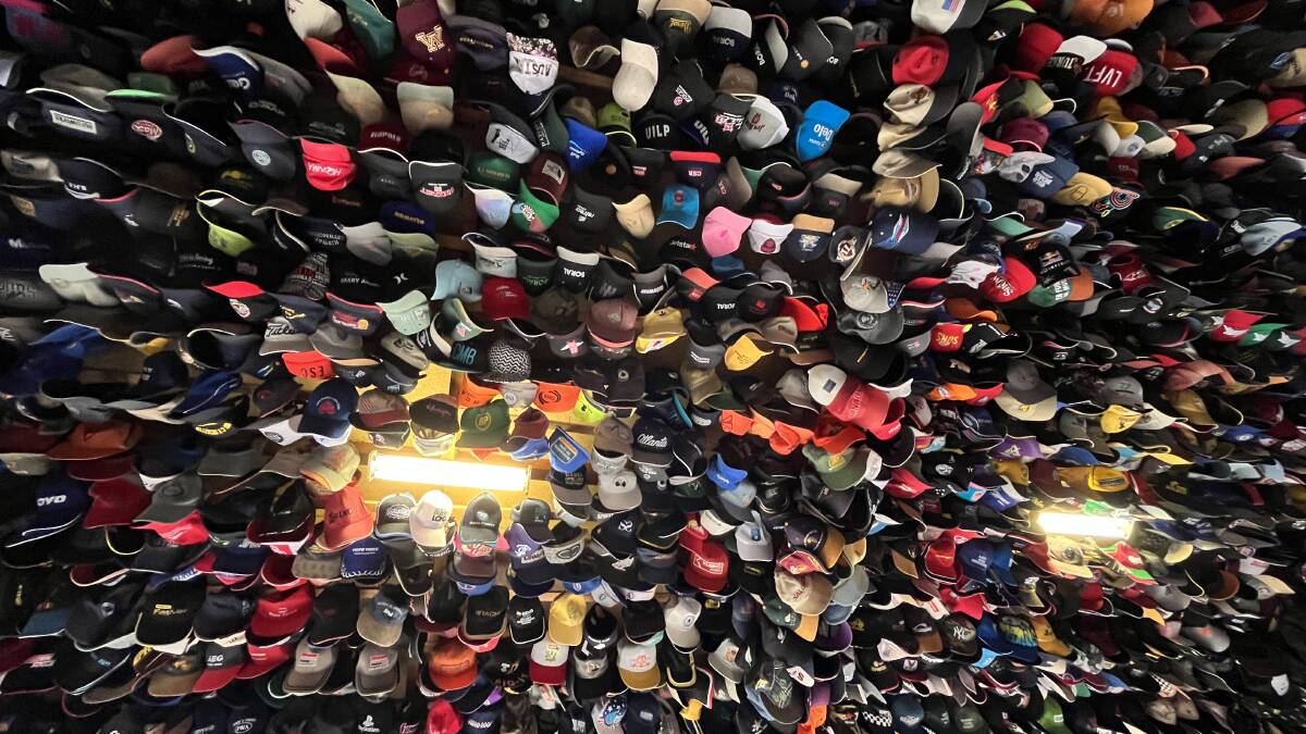 Hat collection when looking up from the garage floor. Picture by James Parker
