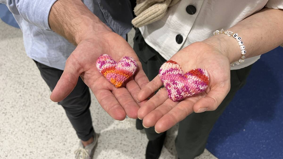 Two knitted hearts were given to Andrew and Ashleigh, while Ashleigh wears a bracelet with Robin's name. Picture by James Parker