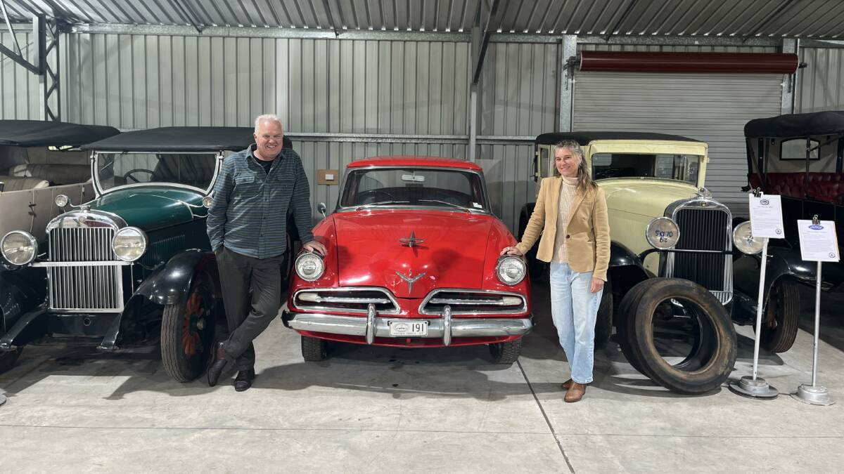 Brother and sister, Andrew Learmont and Louise Learmont alongside a dashing red 1953 Studebaker sedan. Picture by James Parker