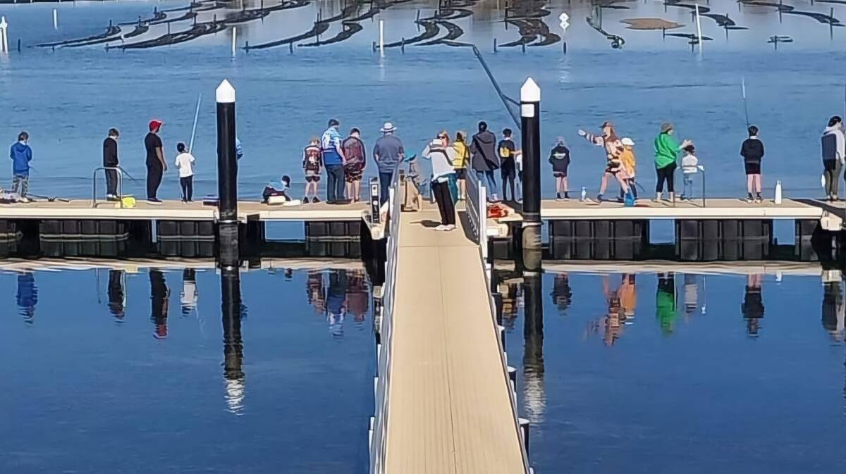 The MBGLAC jetty full of people trying to catch a salmon at Spencer Park, Merimbula. Picture supplied
