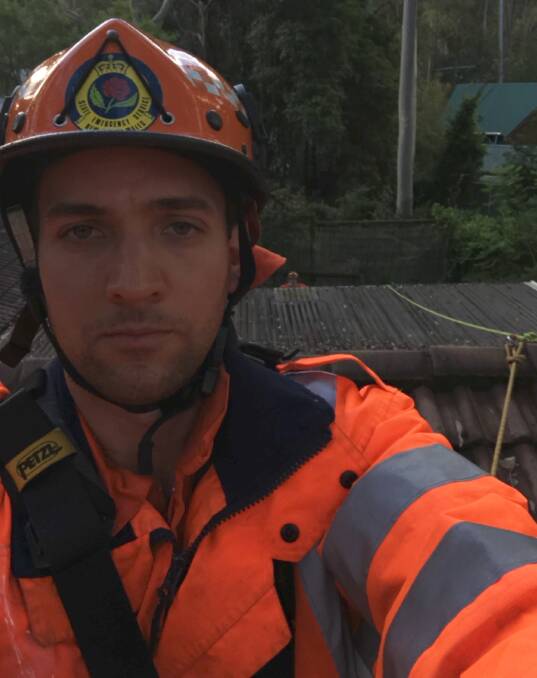 Seb Bachler of Moruya SES assists with roof damage at Mystery Bay.