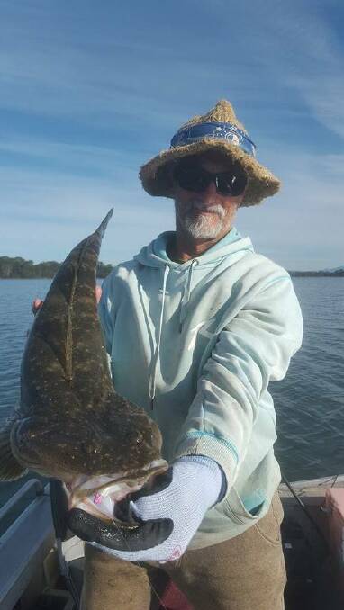 1000 CASTS: Mark "Hippie" Carradus of Narooma with the 75cm dusky flathead he got at Tuross Lake after 1000 casts at the weekend. Photo Narooma Ocean Hut Compleat Angler Facebook