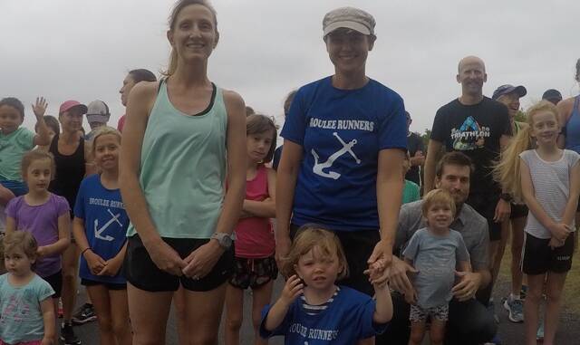 Milestones: Jo Flood recorded her 100th run and young Nina McPherson made it to 30 - with a little help from mum Michelle - at Wednesday's Broulee Runners event. 