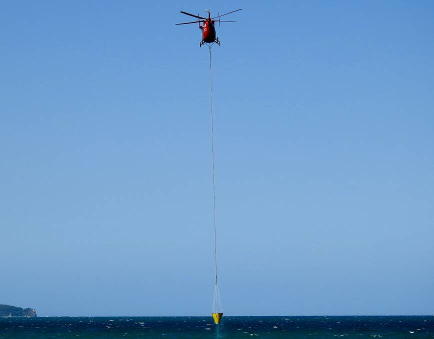 HELP FROM ABOVE: Aviation resources have been used to contain the bushfire at Surf Beach. PHOTO: Don Wallace.