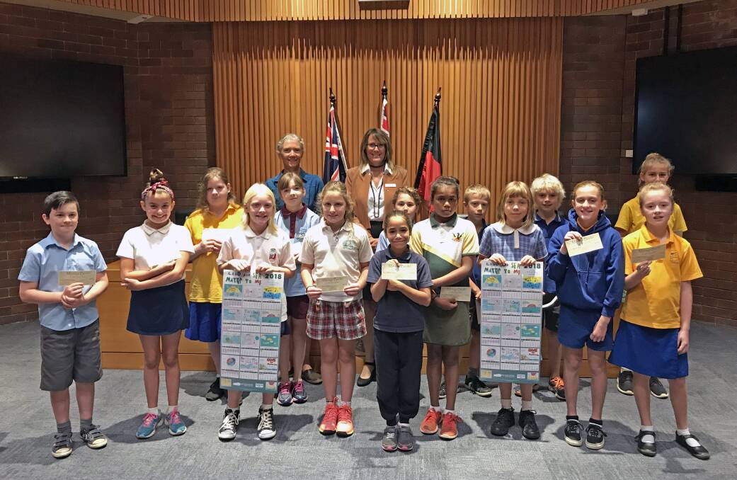 Joint effort: Council’s Bernadette Davis and Mayor Liz Innes with Eurobodalla students who contributed to the 2018 environmental calendar.