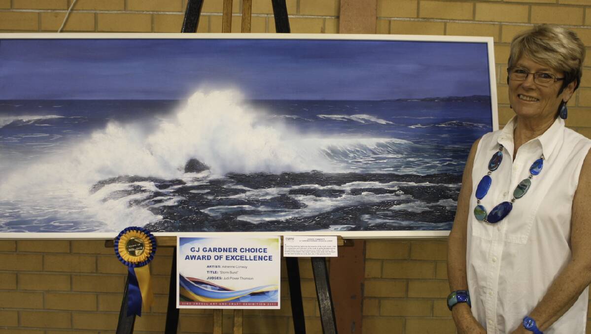  Multi-talented: Adrienne Conway with her award-winning painting “Storm Burst”.  Judges said the painting captured the essence of the South Coast.