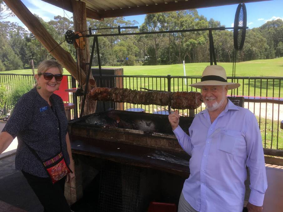 Christmas feast: Karen MacLatchy and Bob Thurbon admiring the sizzle and aromas of the spit roast before it was served.