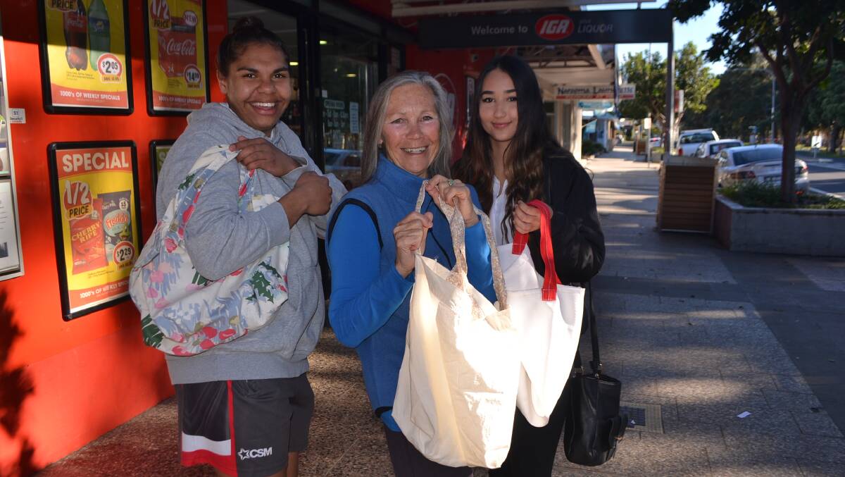 GLLAD Bags founder Mukti with Nyeasha Hoskins-Moore and Lili Goyma in front of the Narooma IGA. GLLAD sews and distributes fabric bags.