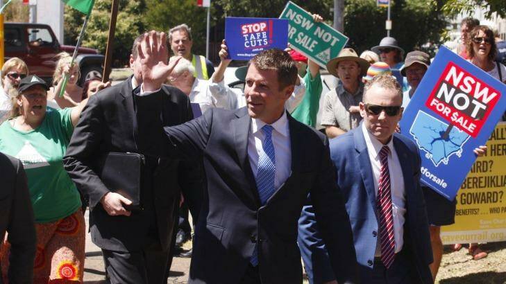 NSW Premier Mike Baird is met by protesters at Hunter TAFE. Photo: Brockwell Perks